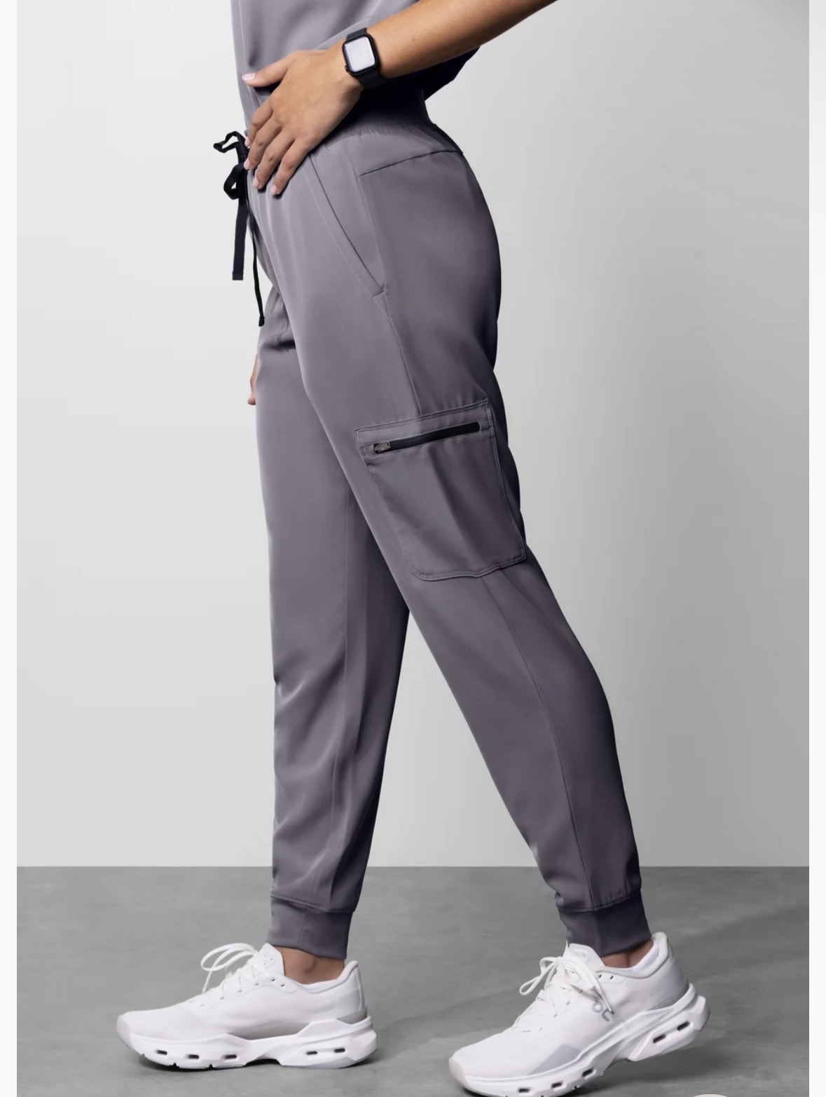 Full length image in gray medical scrubs