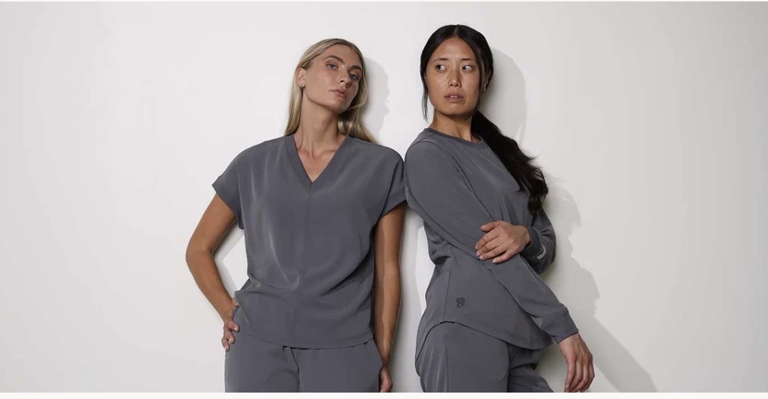 Two models wearing gray medical scrubs